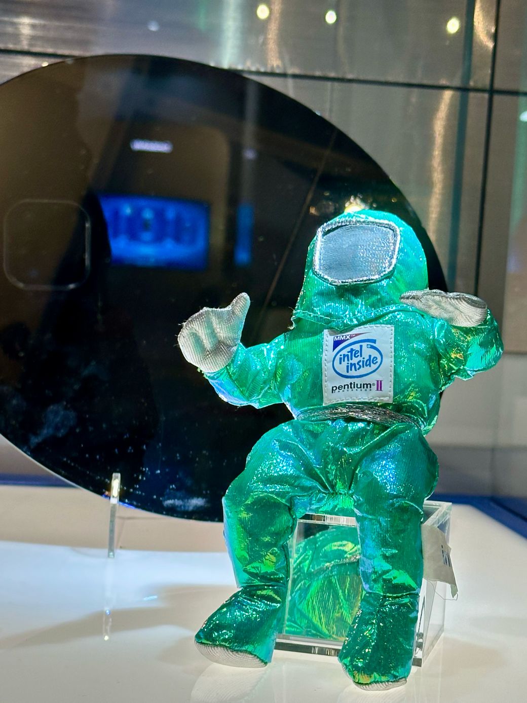 Intel Bunny People doll in a cleanroom suit in front of a silicon wafer at the Intel Museum